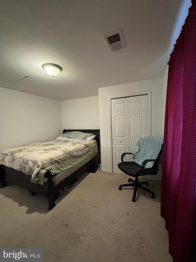 carpeted bedroom with a closet