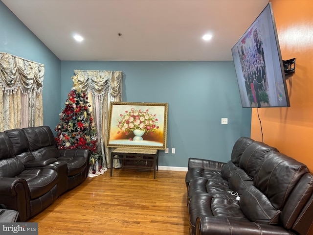 living room featuring light hardwood / wood-style floors and vaulted ceiling