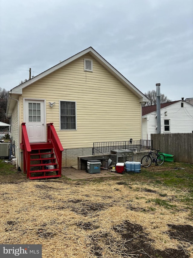 rear view of house with central AC