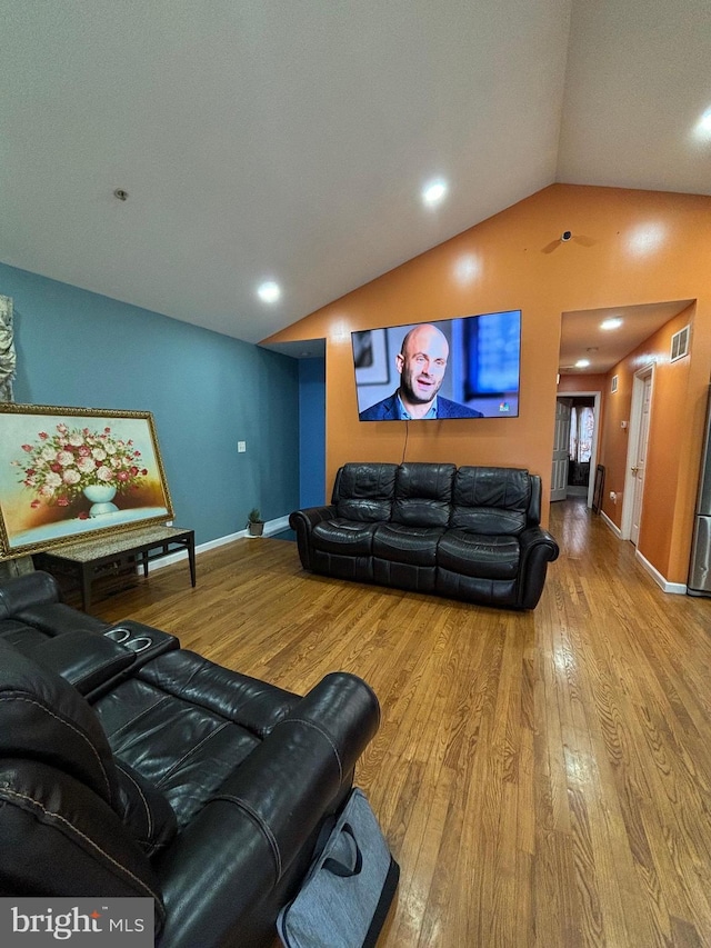 living room with hardwood / wood-style flooring and lofted ceiling