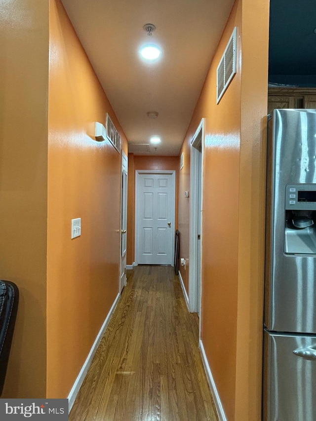 corridor featuring hardwood / wood-style floors