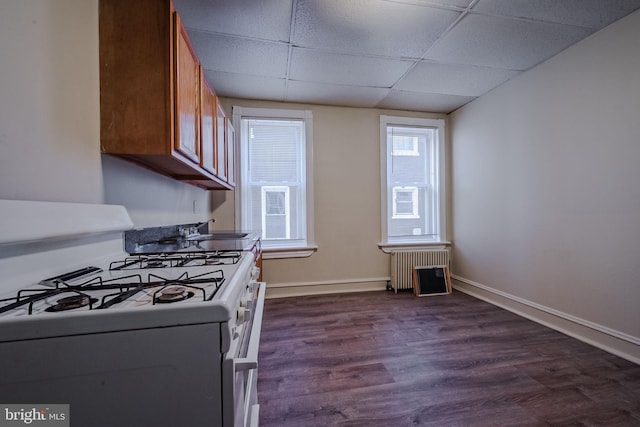 kitchen with a paneled ceiling, radiator, dark wood-type flooring, sink, and white range with gas stovetop