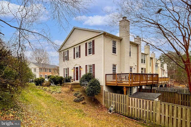 back of house featuring a wooden deck