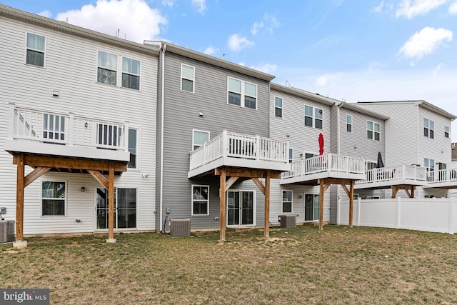 back of property featuring central AC unit and a yard