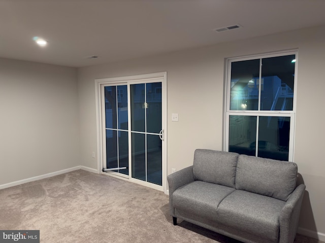 sitting room featuring carpet flooring