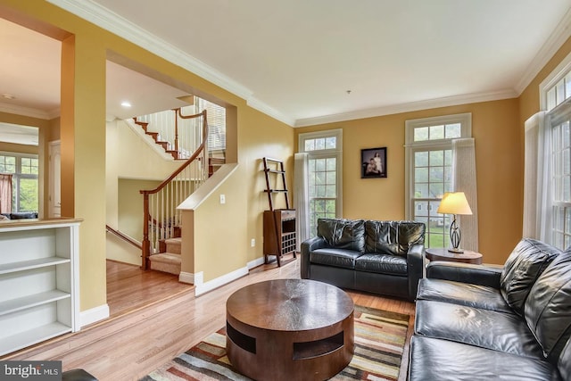 living room featuring light wood-type flooring and ornamental molding