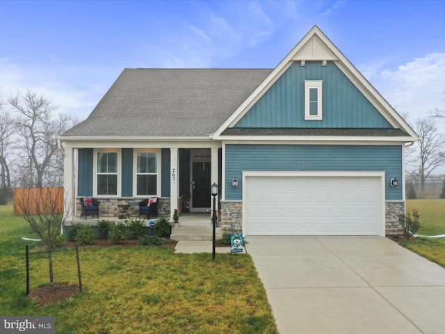 craftsman-style house featuring a garage and a front yard