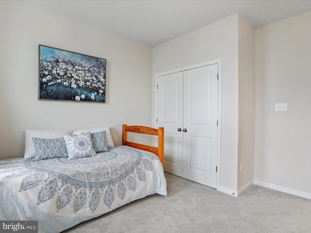 carpeted bedroom with a closet