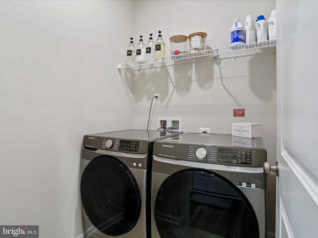 clothes washing area featuring washer and clothes dryer