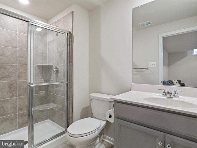 bathroom featuring toilet, vanity, and walk in shower