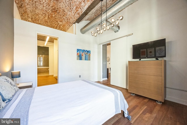 bedroom featuring dark wood-type flooring and brick ceiling