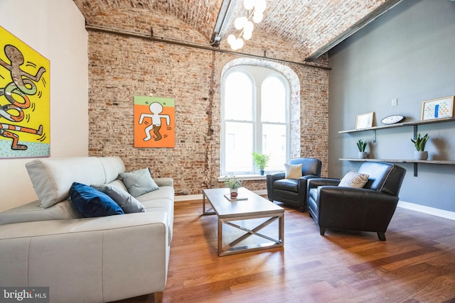 interior space with brick wall, high vaulted ceiling, brick ceiling, and wood-type flooring