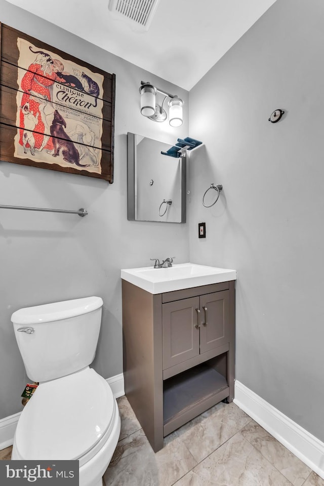 bathroom with vanity and toilet