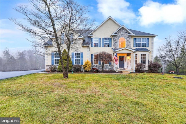 colonial-style house featuring a front lawn