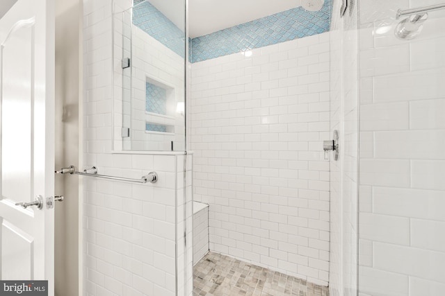 bathroom with a shower with door