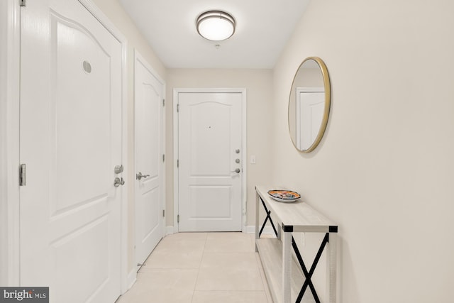 doorway featuring light tile patterned flooring