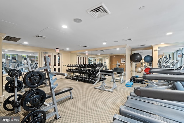 workout area with crown molding and light colored carpet