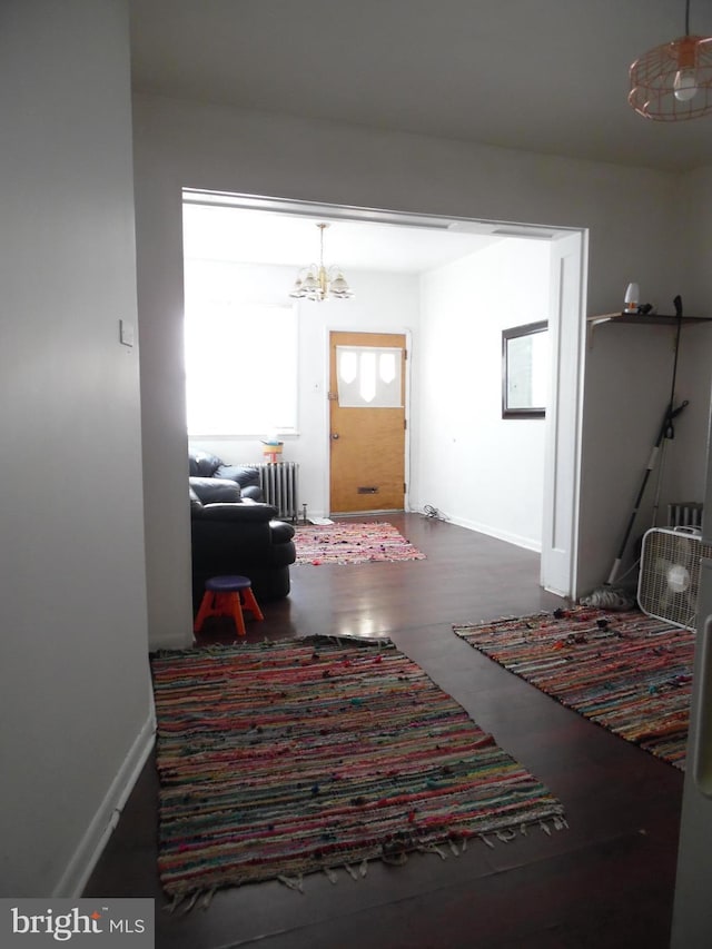 interior space with a chandelier and radiator