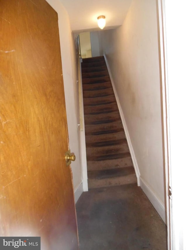 stairs with concrete flooring