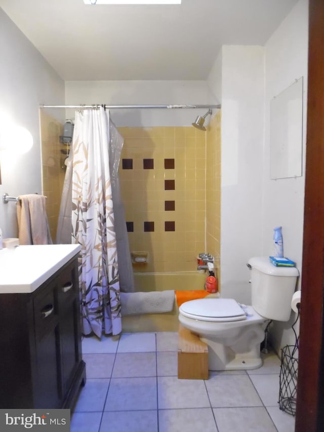 full bathroom featuring tile patterned flooring, vanity, toilet, and shower / bathtub combination with curtain