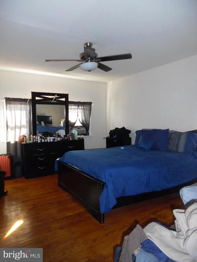 bedroom featuring ceiling fan and dark wood-type flooring