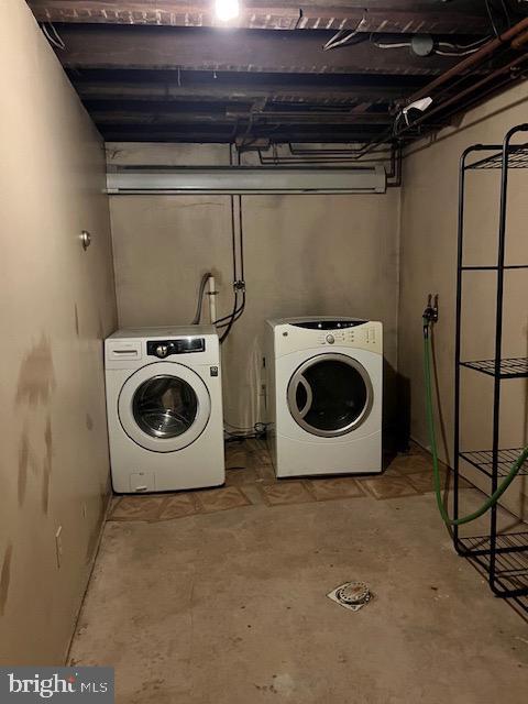 clothes washing area with separate washer and dryer