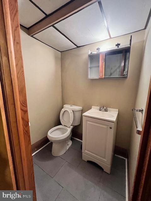 bathroom with tile patterned flooring, vanity, and toilet