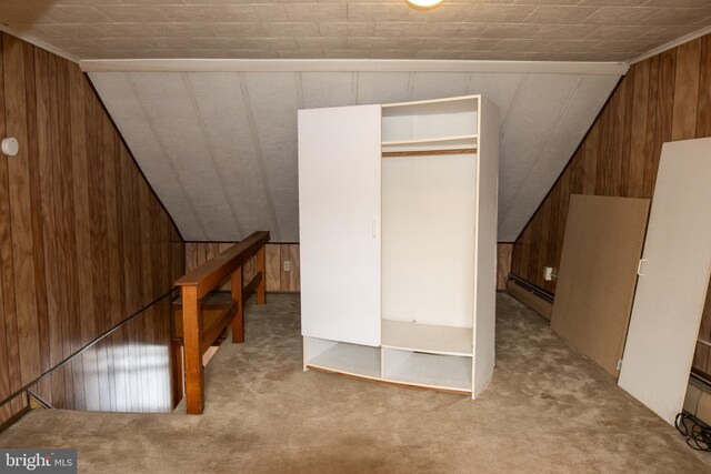 bonus room with a baseboard heating unit, light colored carpet, wooden walls, and vaulted ceiling