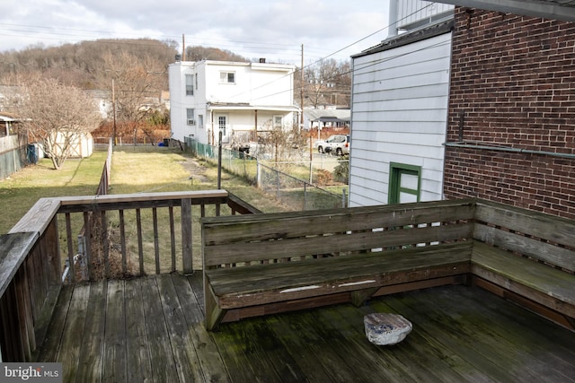 wooden deck with a lawn