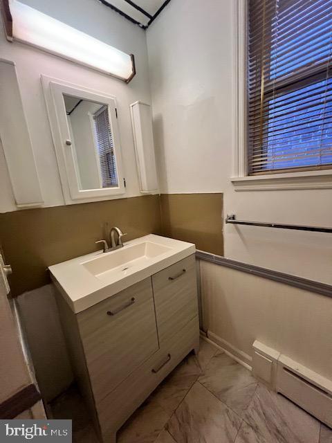 bathroom featuring vanity and a baseboard heating unit