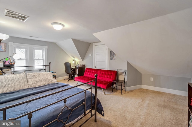 bedroom featuring light carpet and vaulted ceiling