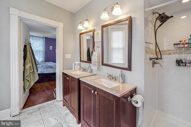 bathroom with tiled shower, wood-type flooring, and a healthy amount of sunlight