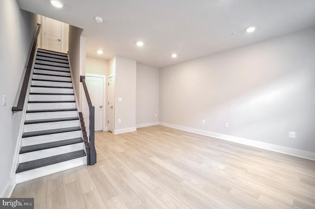 basement with light hardwood / wood-style floors