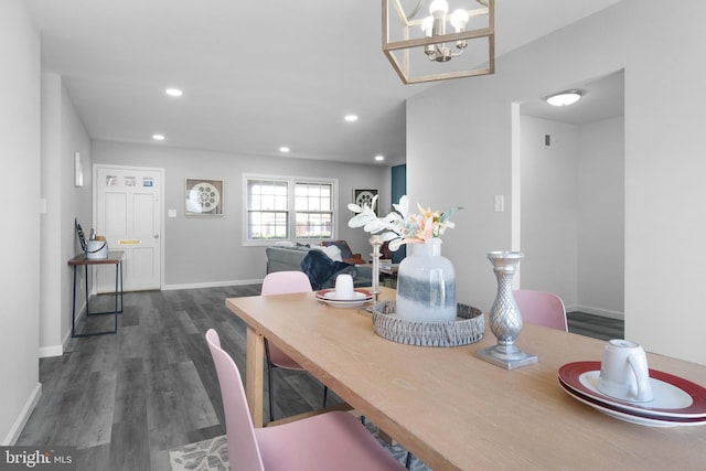 dining area featuring a chandelier and dark hardwood / wood-style floors