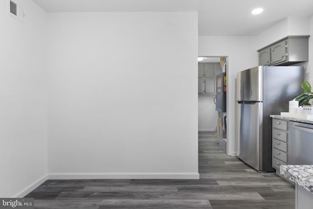 kitchen featuring gray cabinets, dark wood-type flooring, and appliances with stainless steel finishes