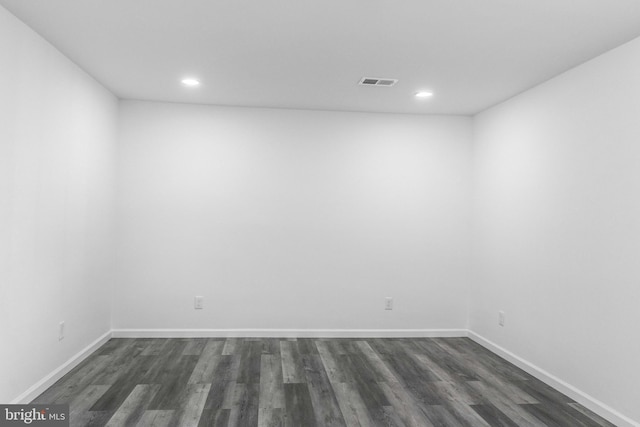 spare room with dark hardwood / wood-style flooring