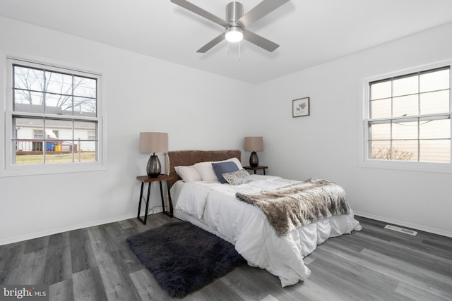 bedroom with ceiling fan and dark hardwood / wood-style flooring