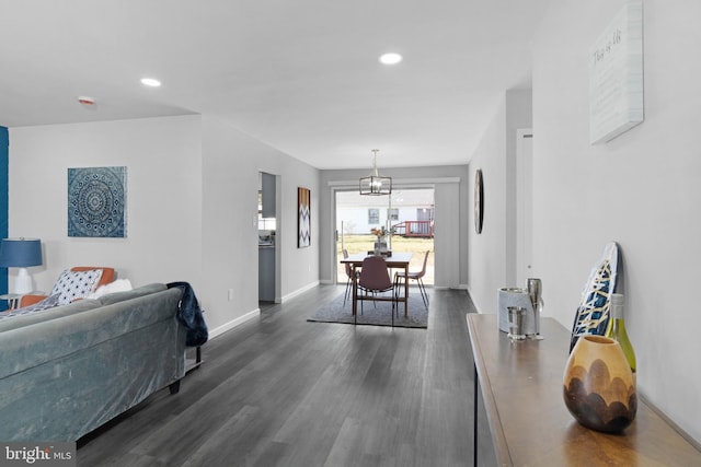 dining area featuring dark hardwood / wood-style flooring and a chandelier