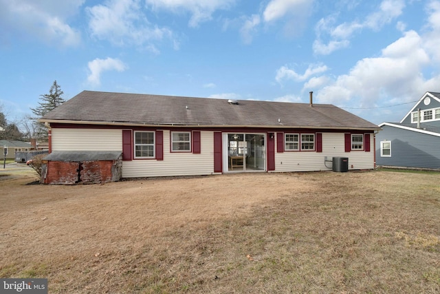 back of house with a lawn and cooling unit