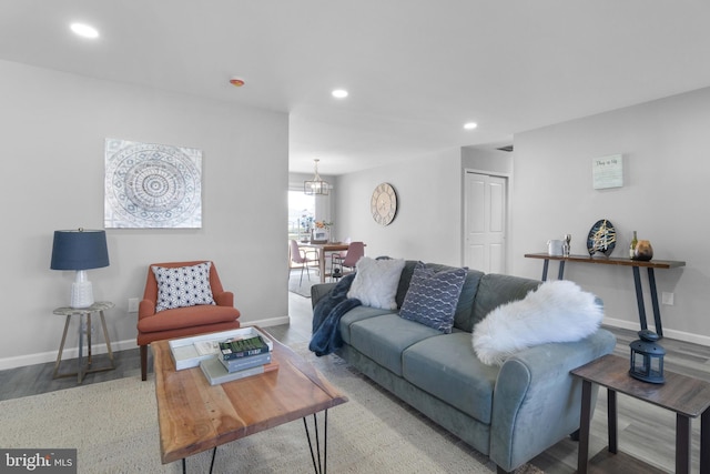 living room with hardwood / wood-style floors and an inviting chandelier