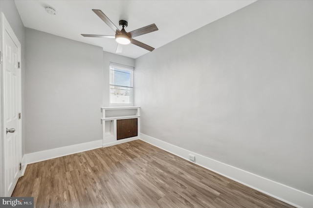 unfurnished room with hardwood / wood-style floors and ceiling fan