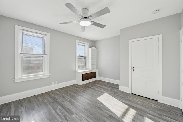 interior space with ceiling fan, a closet, and hardwood / wood-style flooring