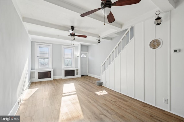 unfurnished living room with beam ceiling, ceiling fan, and light hardwood / wood-style floors