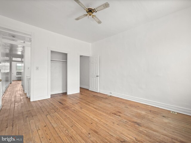 unfurnished bedroom with ceiling fan and light hardwood / wood-style flooring