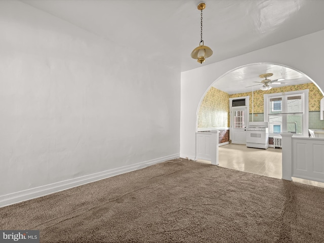 spare room featuring ceiling fan and light colored carpet