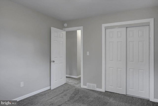 unfurnished bedroom featuring carpet and a closet