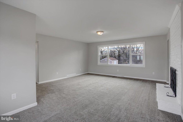 unfurnished living room featuring carpet floors and a fireplace