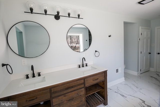 bathroom featuring vanity and toilet