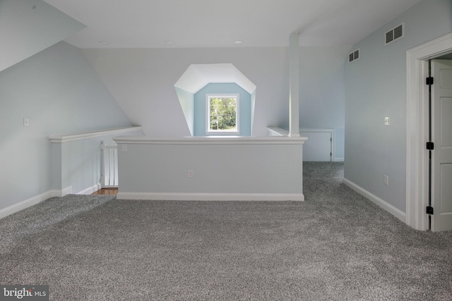 additional living space with carpet flooring and lofted ceiling