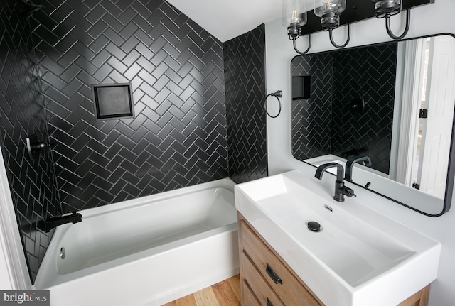 bathroom featuring a bathtub, vanity, and wood-type flooring